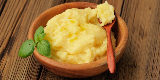 a bowl of cheesy polenta with basil