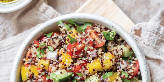 Top view of Quinoa Tabbouleh in a white bowl on flour sack cloth.