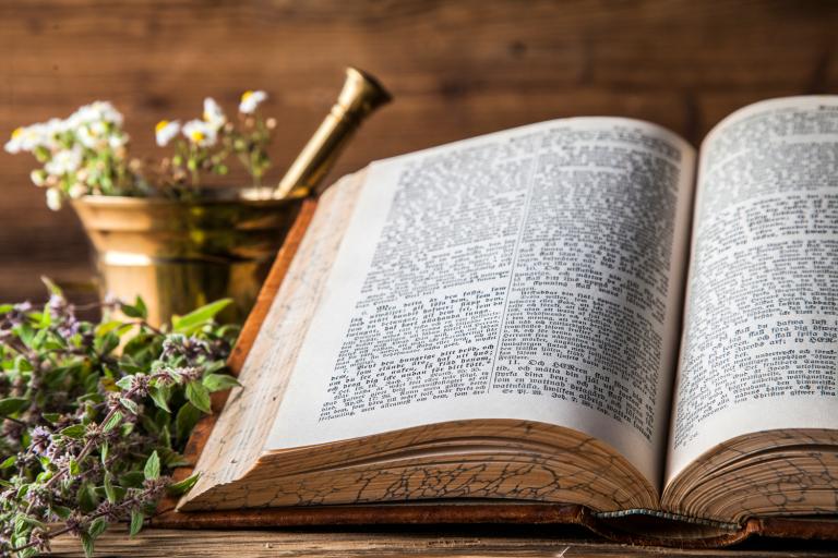 Ancient natural medicine, herbs and old herbal medicine book.