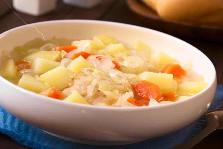 A bowl of vegetarian irish stew with cabbage and potatoes